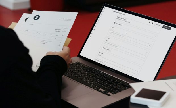A Person Sitting with Laptop and Papers